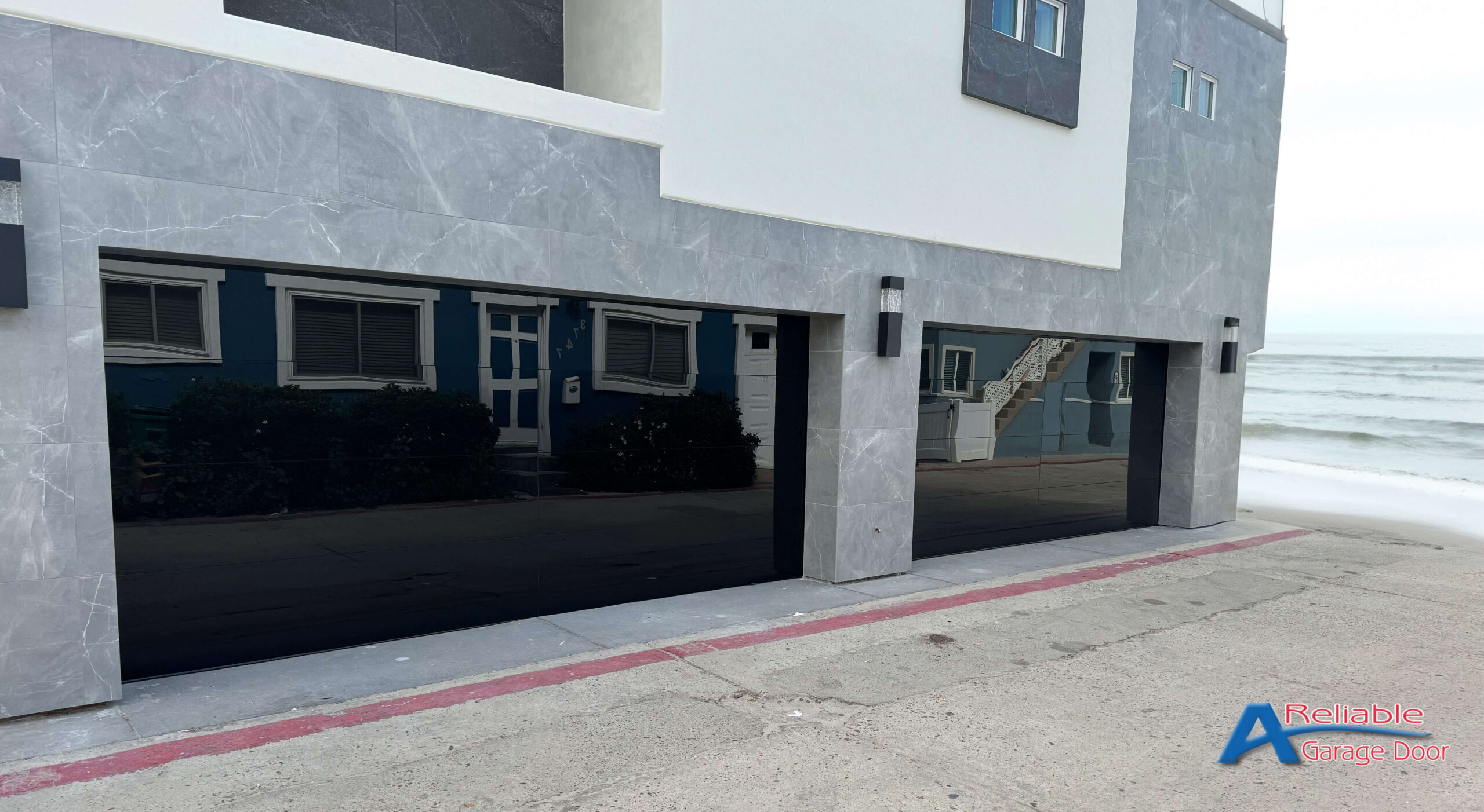 View of a modern home in Pacific Beach with Elegant All Glass Doors, offering a seamless transition between interior comfort and scenic coastal views.