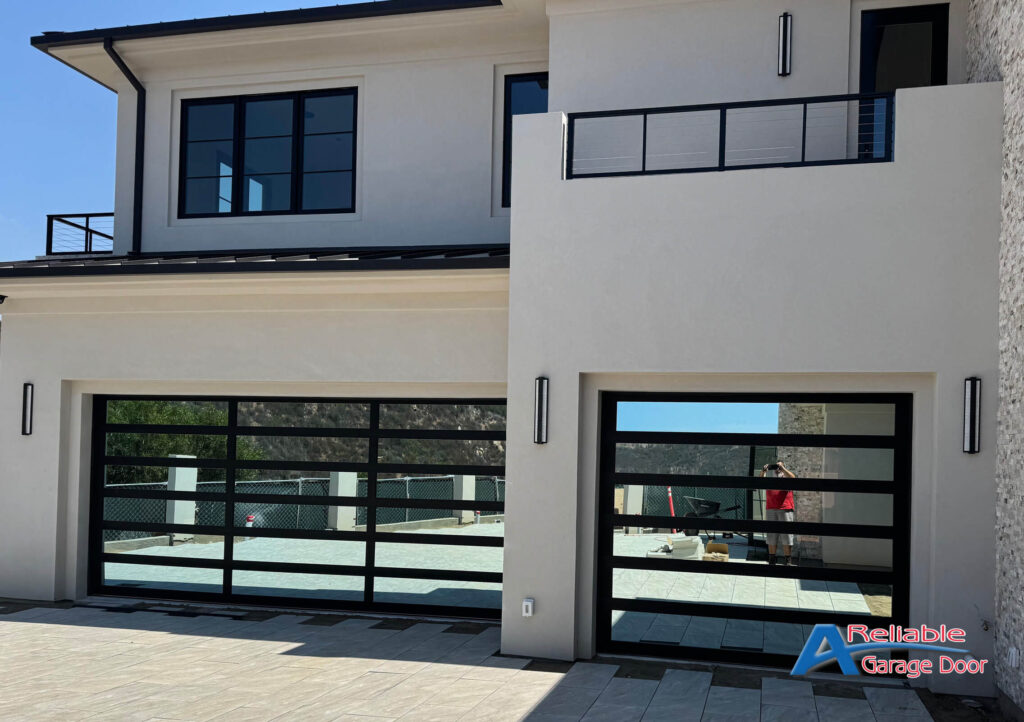 Close-up of Clopay mirrored glass garage door installed on a modern home