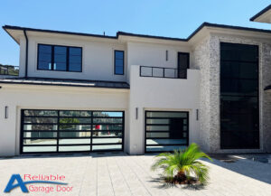Sleek Clopay mirrored glass garage door reflecting the surroundings, installed by A Reliable Garage Door